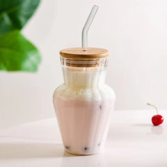 Curved ribbed glass tumbler